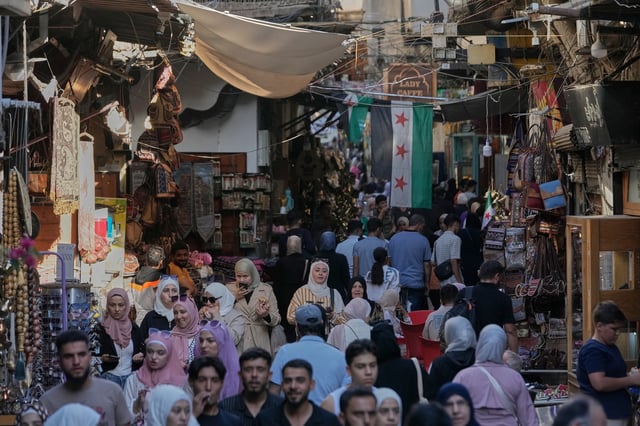 People walk along an alley in the old city of Damascus, Syria, Oct. 2, 2025 (AP photo by Hussein Malla).