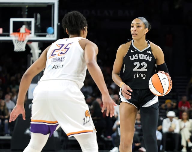 A'ja Wilson #22 of the Las Vegas Aces brings the ball up the court against Alyssa Thomas #25 of the Phoenix Mercury in the third quarter of their game at Michelob ULTRA Arena on August 21, 2025 in Las Vegas, Nevada. The Aces defeated the Mercury 83-61.