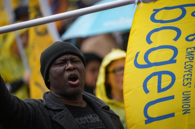 A member of the B.C. General Employees' Union (BCGEU) chants while marching to a rally in Vancouver, on Wednesday, Oct. 1, 2025. THE CANADIAN PRESS/Darryl Dyck