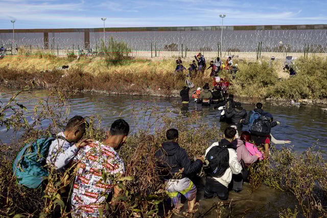 Migrants, predominantly from Venezuela, cross the Rio Grande to seek humanitarian asylum by crossing the border between Mexico and the United States in Ciudad Juarez, Mexico on Dec. 5, 2023. 