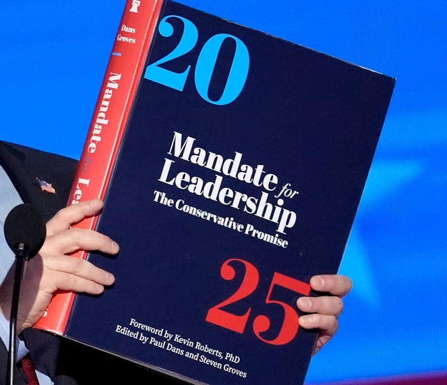 A copy of Project 2025 is held during the Democratic National Convention in Chicago, on August 21, 2024.
