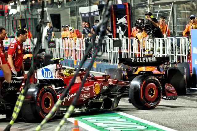 Charles Leclerc and Lando Norris come together in the pitlane. Image: XPB Images