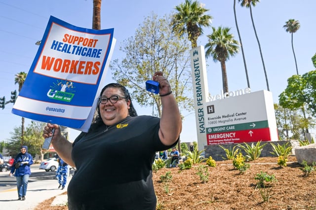 Trisha Garcia stands outside Kaiser Permanente in Riverside as she pickets alongside nurses and hospital staff with the United Nurses Associations of California/Union of Health Care Professionals (UNAC/UHCP) on Friday, Aug. 1, 2025. Contract negotiations are heating up ahead of the national labor agreement’s expiration at the end of September. (Photo by Anjali Sharif-Paul, The Sun/SCNG)