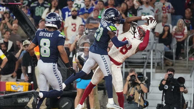 Arizona Cardinals receiver Marvin Harrison Jr. (18) catches a touchdown pass as Seattle Seahawks cornerback Devon Witherspoon (21) defends at State Farm Stadium in Glendale on Sept. 25, 2025. Mandatory Credit: © Joe Rondone/The Republic / USA TODAY NETWORK via Imagn Images