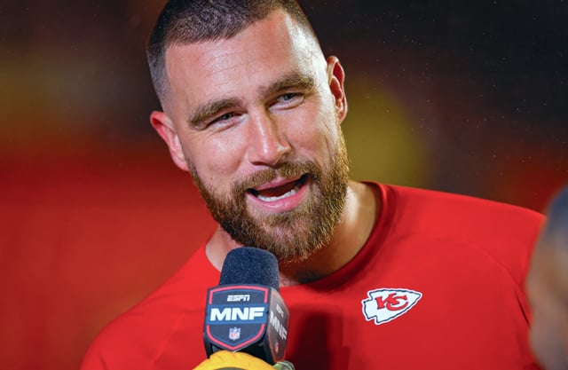 Travis Kelce #87 of the Kansas City Chiefs talks to ESPN Monday Night football television announcers prior to the game against the Philadelphia Eagles at GEHA Field at Arrowhead Stadium on November 20, 2023 in Kansas City, Missouri.