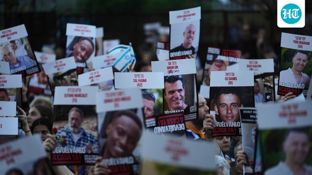 People hold up posters of hostages in Hamas captivity in Gaza, to demand their release, in Buenos Aires, Argentina, Tuesday, Sept. 30, 2025.