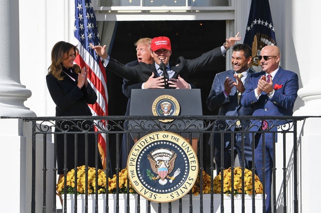 FILE: President Donald Trump embraces Washington Nationals catcher Kurt Suzuki as the 2019 World Series champion Washington Nationals are honored on the South Portico of the White House on Monday, Nov. 4, 2019.