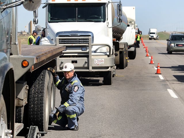 Commercial trucks are inspected during a checkstop on Stoney Trail S.E. in Calgary in 2011.