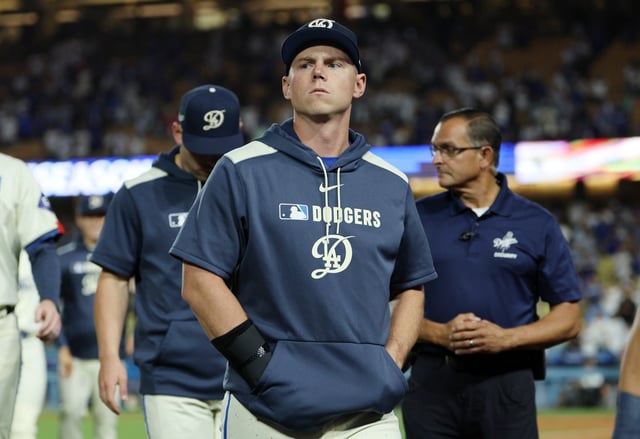 LOS ANGELES, CALIFORNIA - SEPTEMBER 20: Injured catcher Will Smith #16 of the Los Angeles Dodgers, with his right hand in a brace, walks off the field after they defeated the San Francisco Giants, 7-5, at Dodger Stadium on September 20, 2025 in Los Angeles, California. (Photo by Kevork Djansezian/Getty Images)