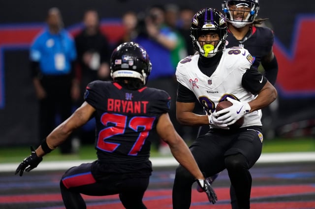 Baltimore Ravens tight end Isaiah Likely (80) catches a 9-yard touchdown pass in front of Houston Texans cornerback Myles Bryant (27) during the first half of an NFL football game, Wednesday, Dec. 25, 2024, in Houston. (AP Photo/David J. Phillip)