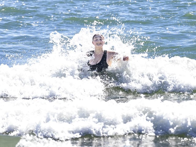 Emilie Fredin of London enjoys the waves at Port Stanley Beach on a summer-like Friday, Oct. 3, 2025. (Derek Ruttan/The London Free Press)