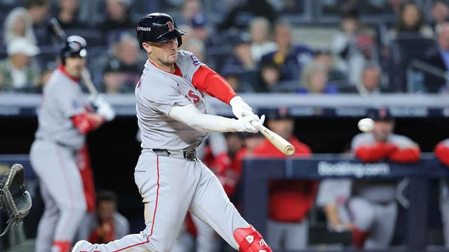Oct 1, 2025; Bronx, New York, USA; Boston Red Sox third baseman Alex Bregman (2) hits a single during the eighth inning against the New York Yankees during game two of the Wildcard round for the 2025 MLB playoffs at Yankee Stadium. Mandatory Credit: Brad Penner-Imagn Images