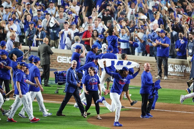 Chicago Cubs players and fans celebrate after the Cubs won Game 3 of the National League wild-card series against the San Diego Padres at Wrigley Field on Oct. 2, 2025. (Eileen T. Meslar/Chicago Tribune)