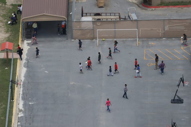 Migrant children spend time in a recreation area outside Casa Presidente, an immigrant shelter for unaccompanied minors, in Brownsville, Texas, U.S., June 23, 2018.  REUTERS/Loren Elliott