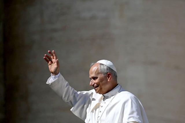 Pope Leo XIV waves to pilgrims at the end of the Weekly General Audience at the Vatican on October 1, 2025.