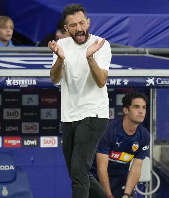 El entrenador del Valencia, Carlos Corberán, da ánimos, ayer, a sus jugadores en el RCDE Stadium. | ENRIC FONTCUBERTA/ EFE