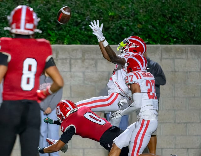 Mater Dei defensive back Danny Lang picks off a pass intended for Orange Lutheran wide receiver Markus Kier (0) in a Trinity League football game in Costa Mesa on Friday, Oct. 3, 2025. (Photo by Paul Rodriguez, Contributing Photographer)