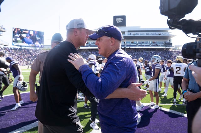 Kansas State football coach Chris Klieman meets with UCF coach Scott Frost after a game at Bill Snyder Family Stadium on Sept. 27, 2025.