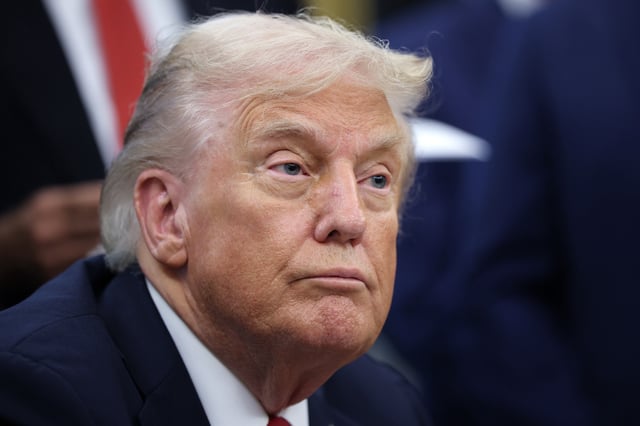 U.S. President Donald Trump answers questions while childhood cancer survivors and their families gather in the Oval Office at the White House on September 30, 2025 in Washington, DC.