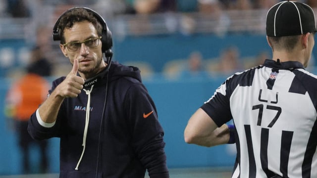 Miami Dolphins coach Mike McDaniel signals his intent to challenge a call Monday, Sept. 29, 2025 at Hard Rock Stadium in Miami Gardens. (Joe Cavaretta/South Florida Sun Sentinel)
