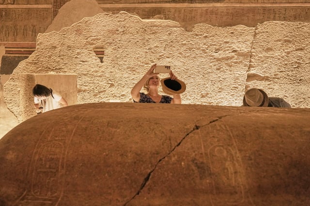 Marzena A. Ozarek, President of mummy research center, films the sarcophagus of King Amenhotep III, who ruled ancient Egypt between 1390 B.C. and 1350 B.C., at his tomb in the Valley of Kings in the southern city of Luxor, Egypt, Saturday, Oct. 4, 2025, as it opened to visitors for the first time in more than two decades. (AP Photo/Amr Nabil)