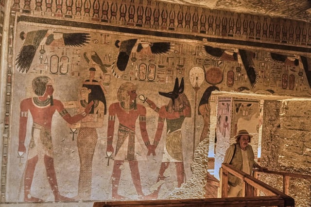 A visitor looks at the tomb of Amenhotep III, who ruled ancient Egypt between 1390 B.C. and 1350 B.C., in the Valley of Kings in the southern city of Luxor, Egypt, Saturday, Oct. 4, 2025, as it opened to visitors for the first time in more than two decades. (AP Photo/Amr Nabil)