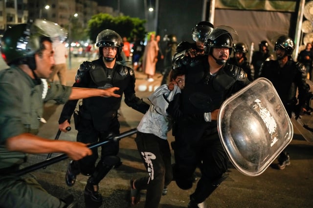 A boy is detained as youth led protests calling for healthcare and education reforms turned violent, in Sale, Morocco, Wednesday, Oct. 1, 2025. (AP Photo/Mosa'ab Elshamy)