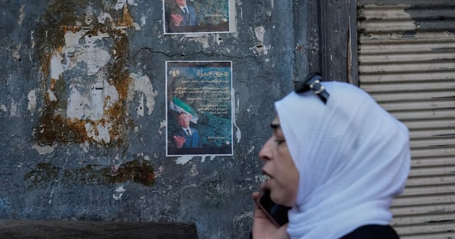 A Syrian passes posters showing Syrian-American Jewish candidate Henry Hamra, a candidate for Sunday's parliamentary elections, in the Jewish neighbourhood of old Damascus on October 3. AP