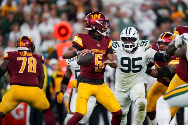 GREEN BAY, WISCONSIN - SEPTEMBER 11: Jayden Daniels #5 of the Washington Commanders looks to make a pass during the first half of an NFL football game against the Green Bay Packers at Lambeau Field on September 11, 2025 in Green Bay, Wisconsin. (Photo by Todd Rosenberg/Getty Images)