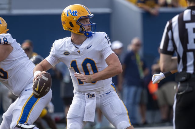 Eli Holstein #10 of the Pittsburgh Panthers drops back to pass during a game against the West Virginia Mountaineers at Milan Puskar Stadium on September 13, 2025 in Morgantown, West Virginia.