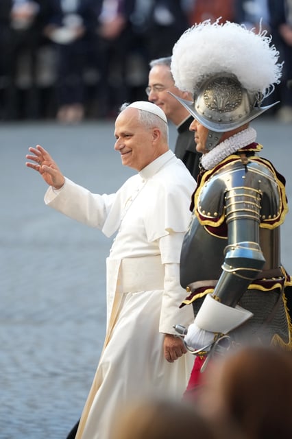 Pope Leo XIV, flanked by Pontifical Swiss Guard's 35th Commander Christoph Graf, right, attends the swering in ceremony of 27 Pontifical Swiss Guards cadets in the St. Damasus courtyard at the Vatican, Saturday, Oct. 4, 2025. (AP Photo/Andrew Medichini)