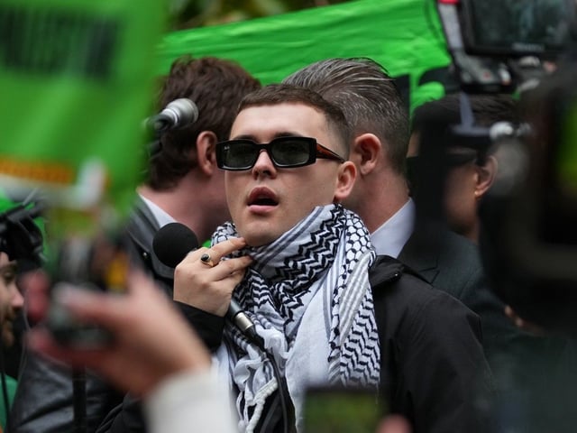 Liam Óg Ó hAnnaidh, aka Mo Chara, a member of the Irish language band Kneecap, celebrates after he left Woolwich Crown Court in London, Friday, Sept. 26, 2025.