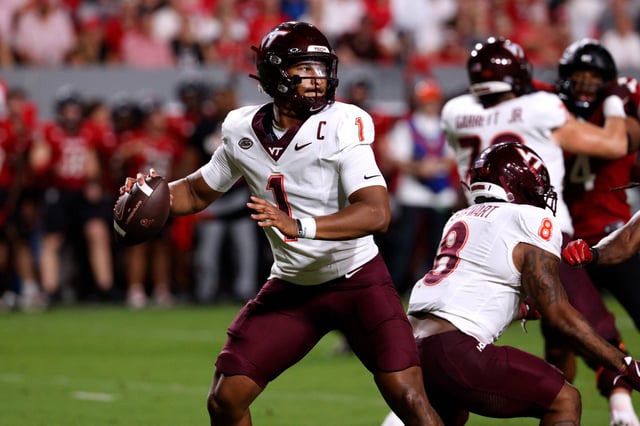 Kyron Drones #1 of the Virginia Tech Hokies drops back to pass against the NC State Wolfpack at Carter-Finley Stadium on September 27, 2025 in Raleigh, North Carolina.