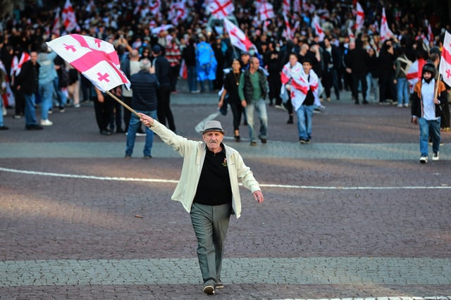 Opposition supporters with Georgian national flags gather in the city center of Tbilisi, Georgia, on Saturday, Oct. 4, 2025, boycotting the municipal elections and call for the release of political opponents. (AP Photo/Zurab Tsertsvadze)
