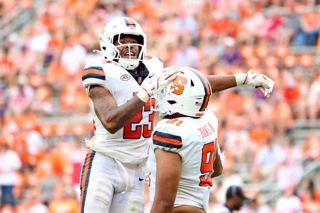 Devin Grant #23 of the Syracuse Orange celebrates his play against the Clemson Tigers with George Rooks #91 of the Syracuse Orange during the third quarter at Memorial Stadium on September 20, 2025 in Clemson, South Carolina.