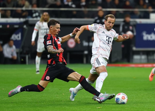 Soccer Football - Bundesliga - Eintracht Frankfurt v Bayern Munich - Deutsche Bank Park, Frankfurt, Germany - October 4, 2025 Bayern Munich's Harry Kane in action with Eintracht Frankfurt's Robin Koch REUTERS/Kai Pfaffenbach