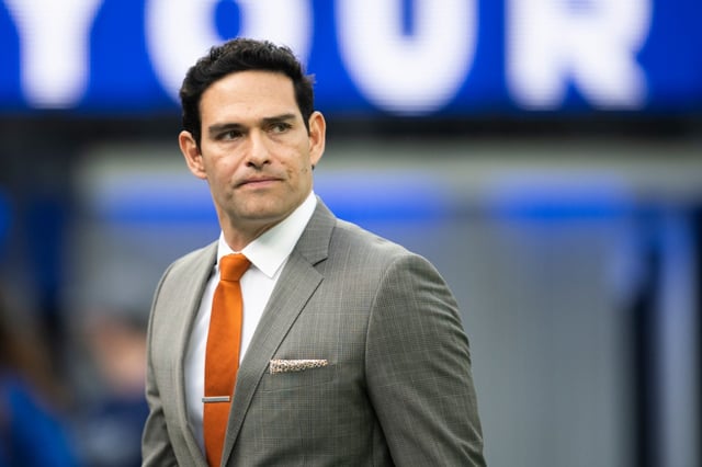 NFL analyst and former USC quarterback Mark Sanchez walks on the field before a game between the Rams and Jacksonville Jaguars on Dec. 5, 2021, at SoFi Stadium. (AP Photo/Kyusung Gong)