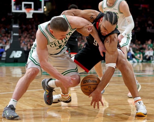 Boston, MA - Jan. 27 - Payton Pritchard #11 of the Boston Celtics and Dillon Brooks #9 of the Houston Rockets go after a loose ball during the second half of the NBA game.  (Photo By Matt Stone/Boston Herald)