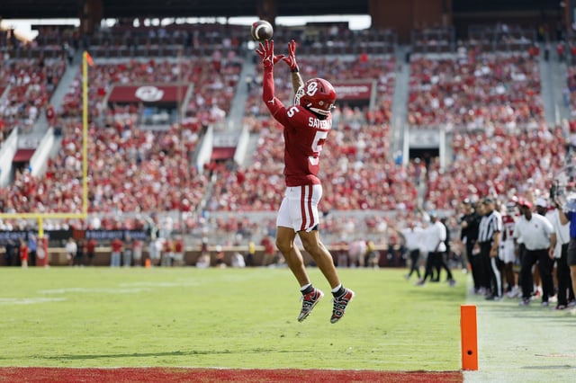 Wide receiver Isaiah Sategna III #5 of the Oklahoma Sooners catches a 24-yard touchdown pass unguarded by the Auburn Tigers in the second quarter at Gaylord Family Oklahoma Memorial Stadium on September 20, 2025 in Norman, Oklahoma. SEC officials later released a statement interpreting the play as an illegal hideout tactic which should have resulted in a 15-yard unsportsmanlike conduct penalty. Oklahoma won 24-17.