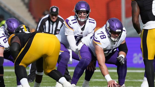 Sep 28, 2025; Dublin, Ireland; Minnesota Vikings quarterback Carson Wentz (11) takes the snap from center Ryan Kelly (78) in the first half against the Pittsburgh Steelers during an NFL International Series game at Croke Park.