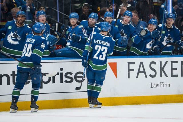 Vancouver Canucks forwards Braeden Cootes and Jonathan Lekkerimaki celebrate with the bench (Bob Frid-Imagn Images)