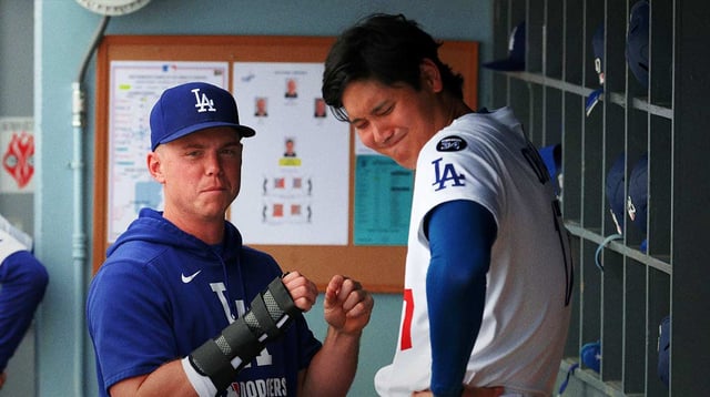 Sep 21, 2025; Los Angeles, California, USA; Los Angeles Dodgers injured catcher Will Smith (left) with his right hand in a brace talks with designated hitter Shohei Ohtani (17) during the eighth inning against the San Francisco Giants at Dodger Stadium. Mandatory Credit: Kiyoshi Mio-Imagn Images