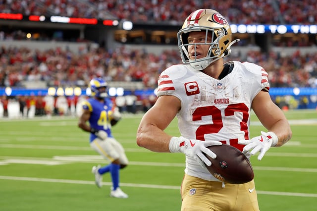 Christian McCaffrey #23 of the San Francisco 49ers reacts after catching a pass for a touchdown against Troy Reeder #51 of the Los Angeles Rams during the second quarter at SoFi Stadium on October 02, 2025 in Inglewood, California.