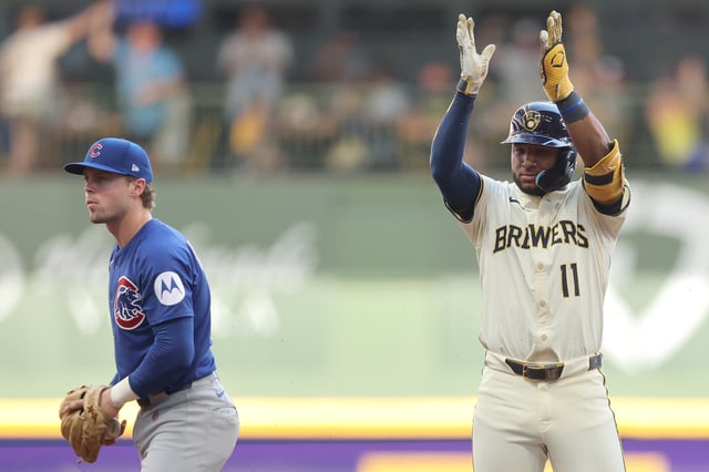 MILWAUKEE, WISCONSIN - OCTOBER 04: Jackson Chourio #11 of the Milwaukee Brewers (R) reacts after hitting a double against the Chicago Cubs during the first inning in game one of the Division Series at American Family Field on October 04, 2025 in Milwaukee, Wisconsin. (Photo by Michael Reaves/Getty Images)