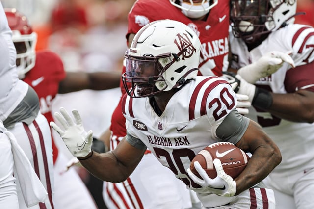 Maurice Edwards IV #20 of the Alabama A&M Bulldogs runs the ball during a game against the Arkansas Razorbacks at Donald W. Reynolds Razorback Stadium on August 30, 2025 in Fayetteville, Arkansas. The Razorbacks defeated the Bulldogs 52-7.