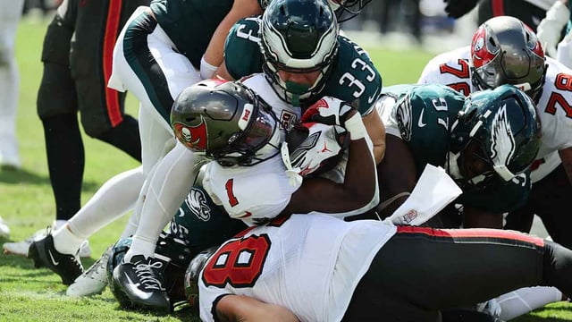 Sep 28, 2025; Tampa, Florida, USA; Tampa Bay Buccaneers running back Rachaad White (1) is tackled by Philadelphia Eagles cornerback Cooper Dejean (33) in the second half at Raymond James Stadium. Mandatory Credit: Kim Klement Neitzel-Imagn Images
