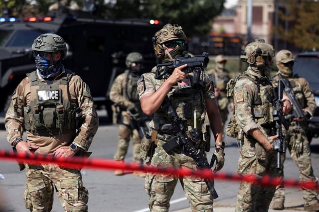 Law enforcement officers during a standoff with U.S. Immigration and Customs Enforcement (ICE) and federal officers in the Little Village neighborhood of Chicago, Illinois, U.S., October 4, 2025. REUTERS/Jim Vondruska