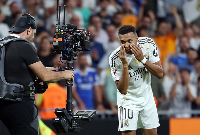 Soccer Football - LaLiga - Real Madrid v Villarreal - Santiago Bernabeu, Madrid, Spain - October 4, 2025 Real Madrid's Kylian Mbappe celebrates scoring their third goal as a television cameraman on the pitch films his reaction REUTERS/Juan Medina
