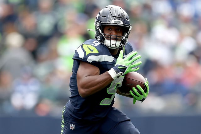Kenneth Walker III #9 of the Seattle Seahawks carries the ball against the New Orleans Saints at Lumen Field on September 21, 2025 in Seattle, Washington.