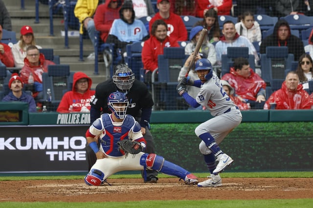 Mookie Betts #50 of the Los Angeles Dodgers at bat with Rafael Marchan #13 of the Philadelphia Phillies behind the plate in the seventh inning during a game at Citizens Bank Park on April 6, 2025 in Philadelphia, Pennsylvania.